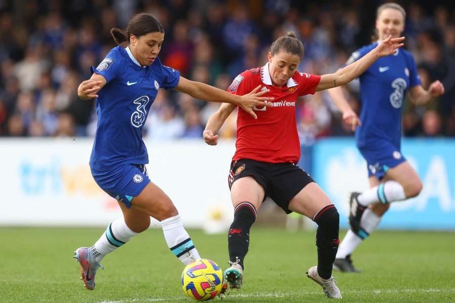 Chelsea's Sam Kerr (L) in action with Manchester United's Ona Batlle