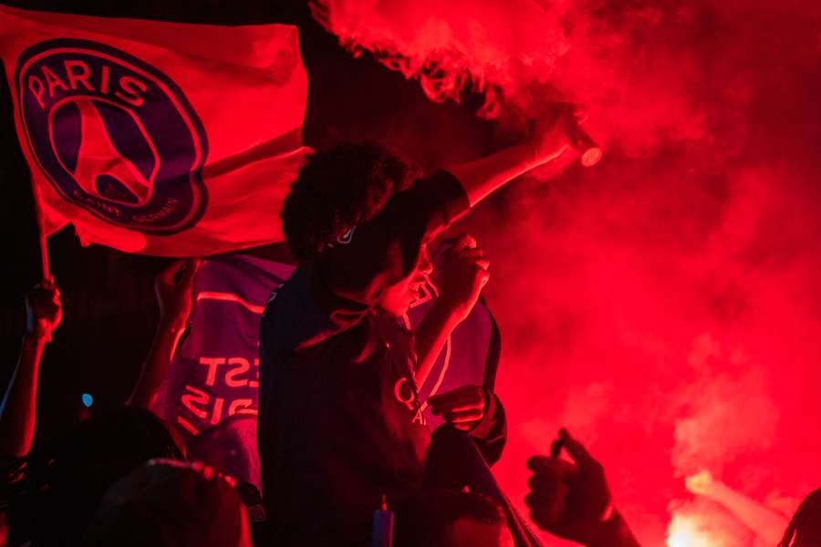 PSG supporters held flares as they celebrated their Champions League win