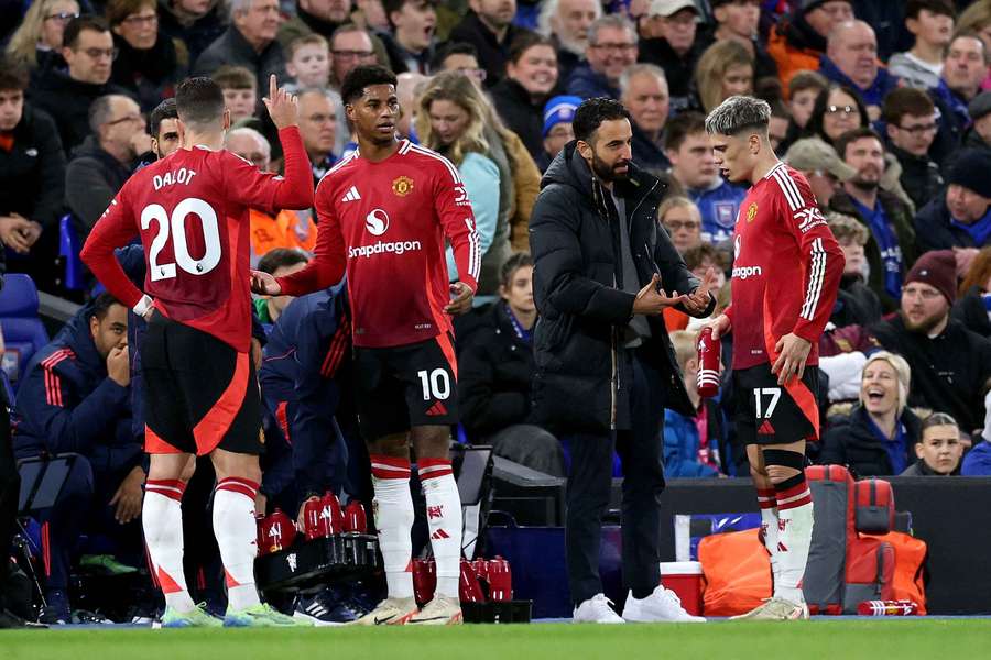 New Manchester United manager Ruben Amorim (second right) speaks to his players