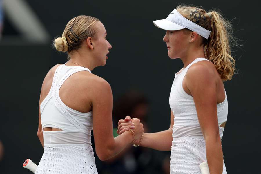 Russia's Mirra Andreeva (R) shakes hands with Russia's Anastasia Potapova after winning their women's singles tennis match