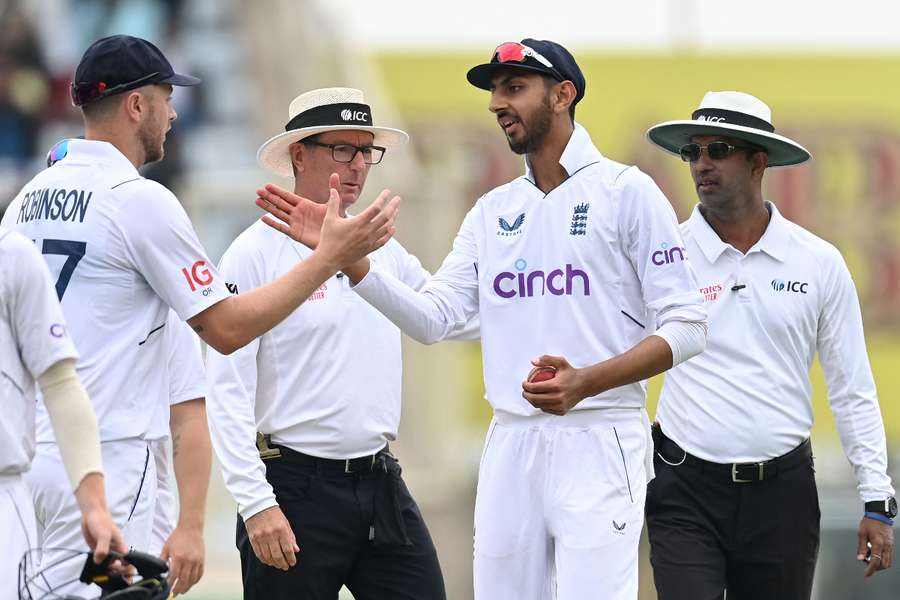 Shoaib Bashir of England is congratulated by Ollie Robinson as he leaves the field