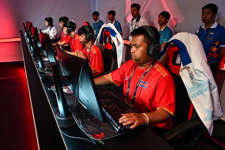 Cambodia's esports players compete in the final match between Cambodia and Malaysia during the 32nd Southeast Asian Games (SEA Games) 