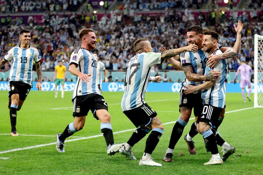Messi celebrates his opener with his teammates