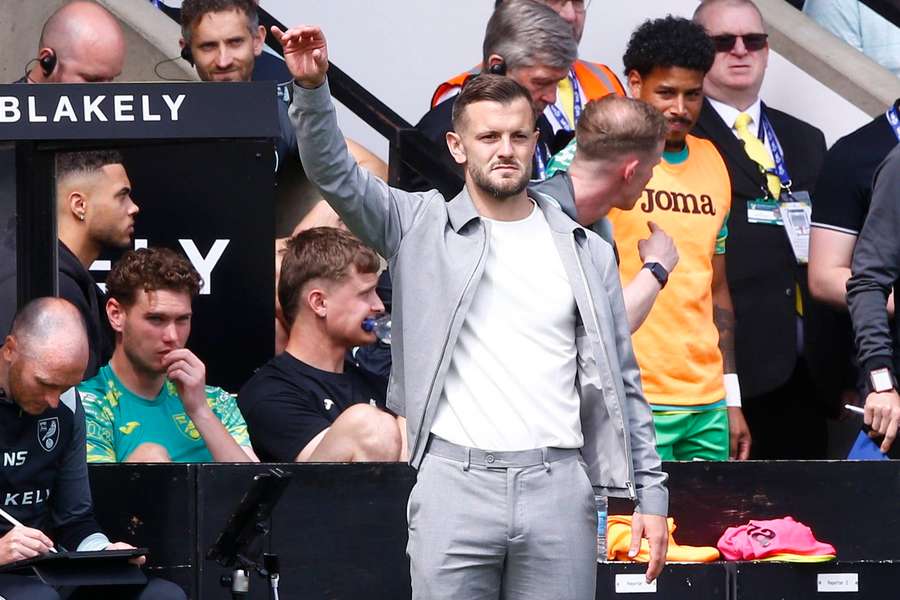 Wilshere watches on from the touchline