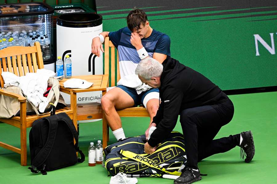 Holger Rune of Denmark receives medical treatment during the singles semifinal match against Ugo Humbert of France