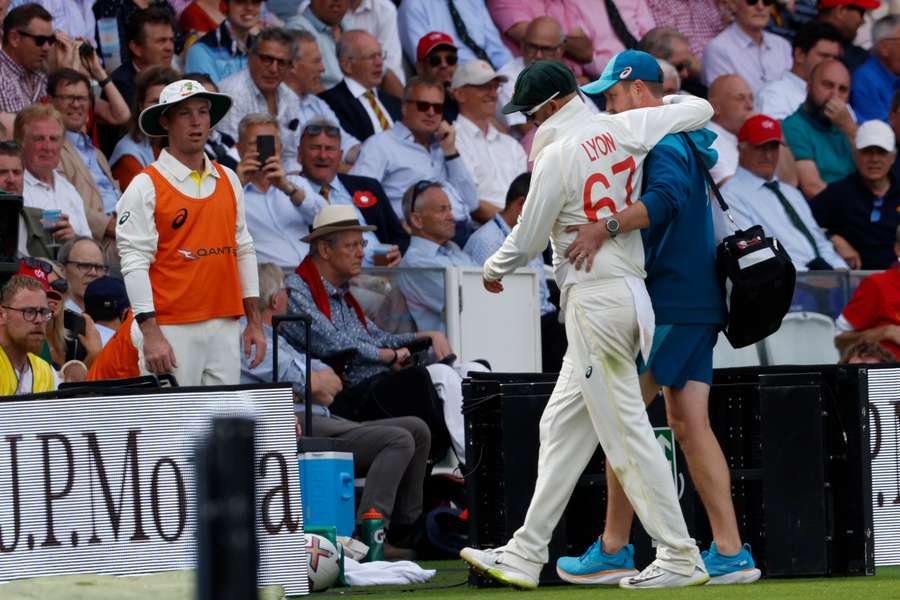 Australia's Nathan Lyon is helped off the field after picking up an injury Australia's Nathan Lyon is helped off the field after picking up an injury