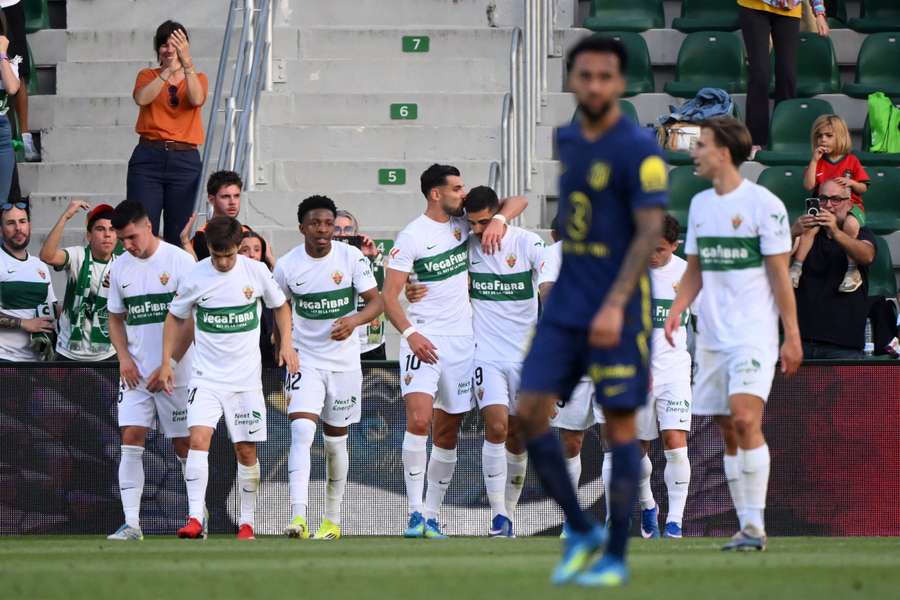 Elche's Portuguese forward #09 Andre Silva is kissed by Elche's Spanish forward #10 Rafa Mir after scoring his team's second goal
