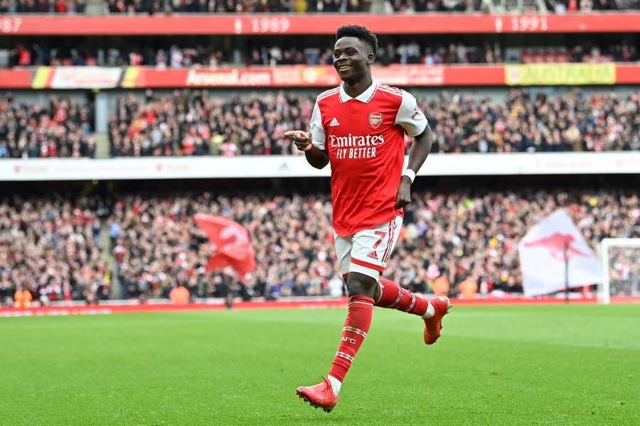 Arsenal's English midfielder Bukayo Saka celebrates after scoring