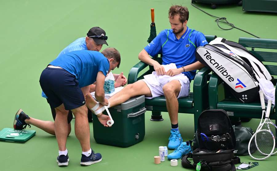 Daniil Medvedev has his foot taped after falling