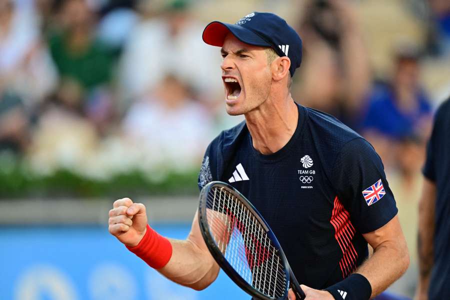 Britain's Andy Murray reacts while playing with Dan Evans