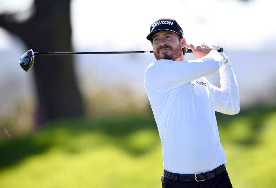 Sam Ryder of the United States plays his shot from the sixth tee