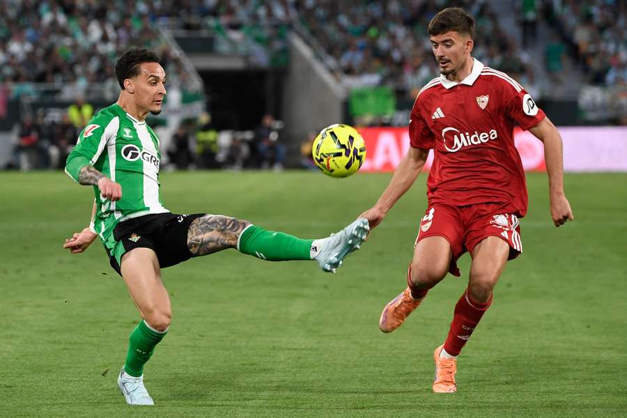 Real Betis' Antony and Sevilla's Kike Salas fight for the ball