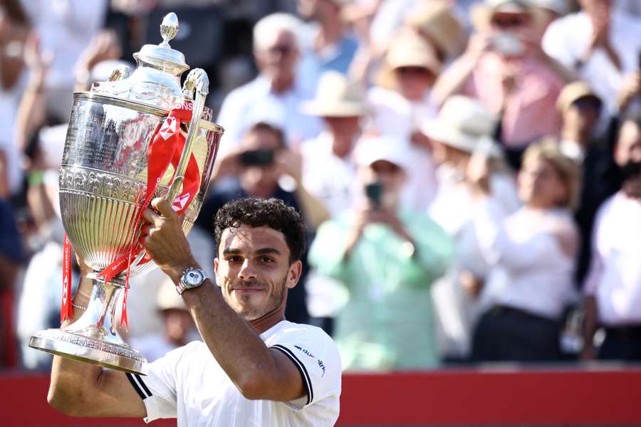 Argentina's Francisco Cerundolo poses for photographers with the winner's trophy after his victory over Tommy Paul at Queen's Argentina's Francisco Cerundolo poses for photographers with the winner's trophy after his victory over Tommy Paul at Queen's