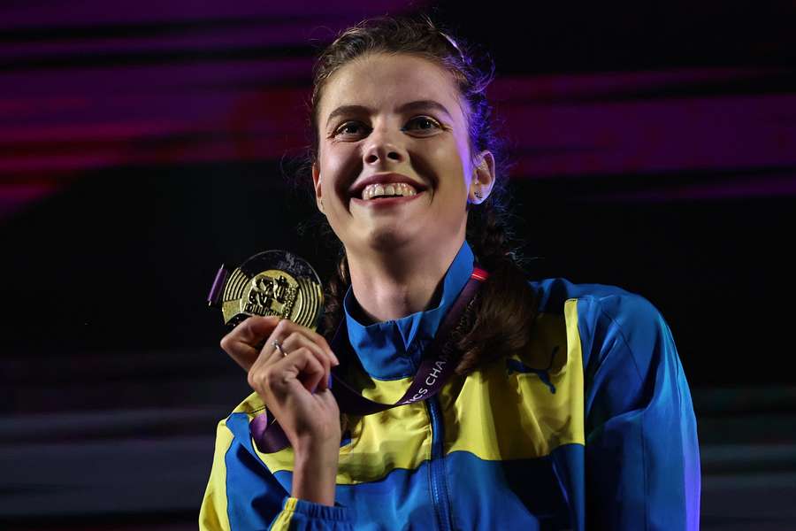 Mahuchikh poses with her gold medal