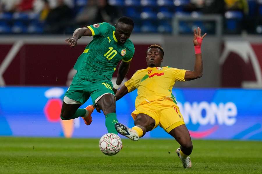 Senegal's Sadio Mane, left, and Benin's Tamimou Ouorou compete for the ball Senegal's Sadio Mane, left, and Benin's Tamimou Ouorou compete for the ball
