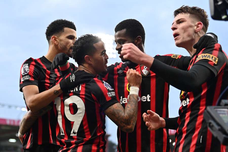 Bournemouth's Justin Kluivert celebrates with teammates after scoring their opening goal against Fulham