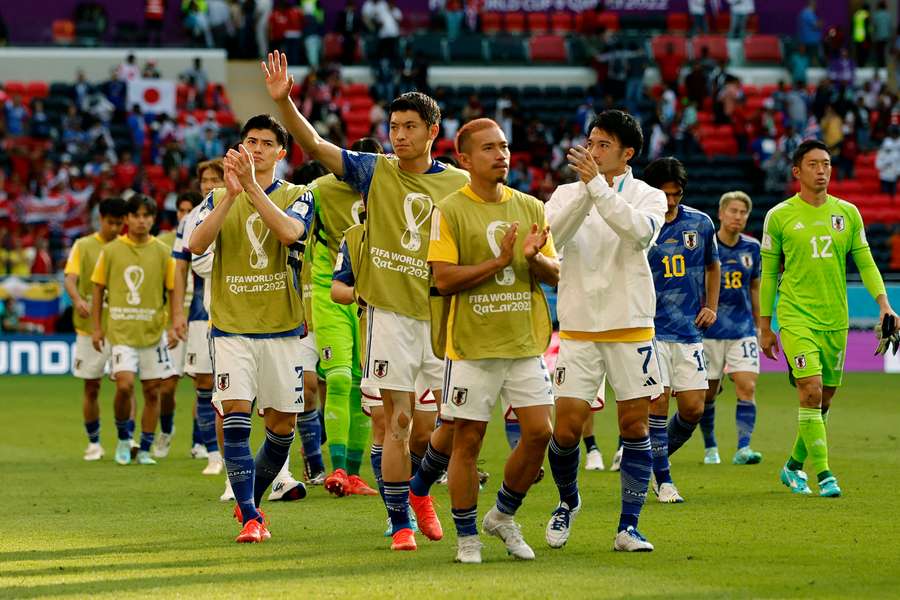 Japan's squad salute their fans after the defeat to Costa Rica