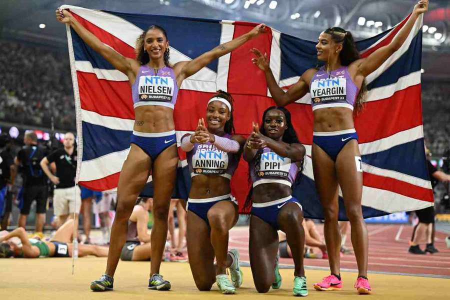 Laviai Nielsen, Amber Anning, Ama Pipi, and Nicole Yeargin celebrate finishing third in the 4x400m relay