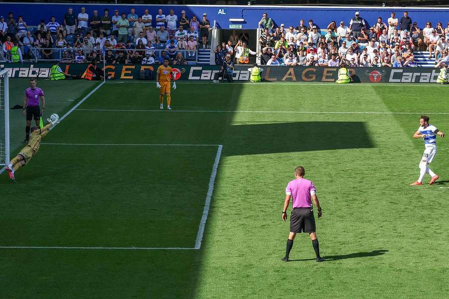 Millwall's  Lukas Jensen saves QPR's Harvey Vale penalty in the Carabao Cup clash