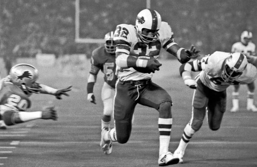 Buffalo Bills' O.J. Simpson rushes through a large hole in 1976