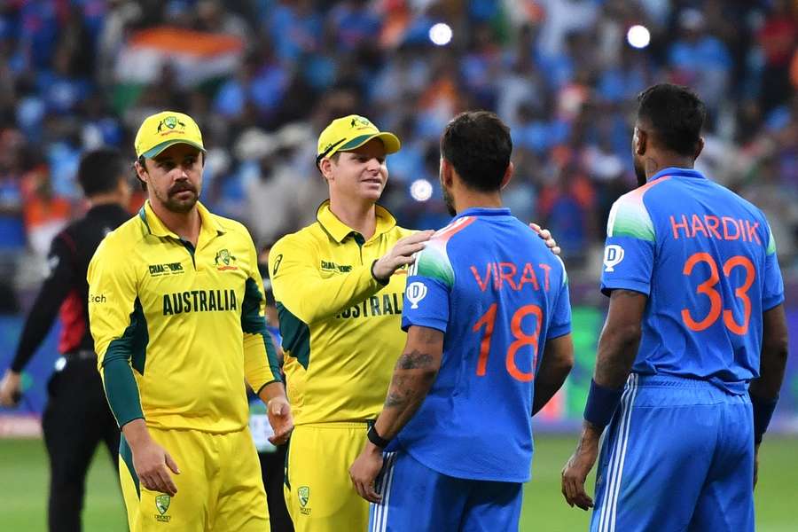 Australia and India players embrace after the game