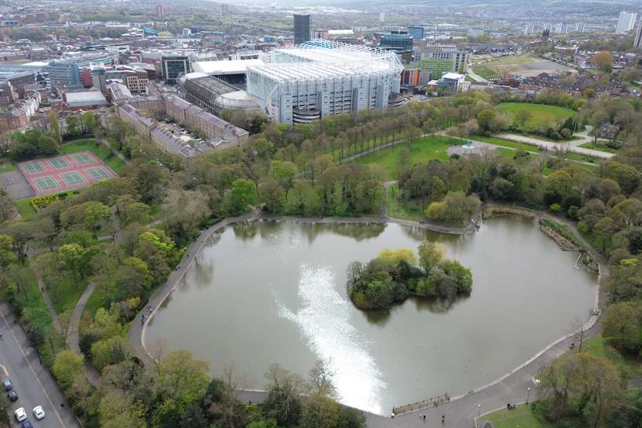 An aerial view is showing Newcastle United's St James' Park with Leazes Park lake in the foreground