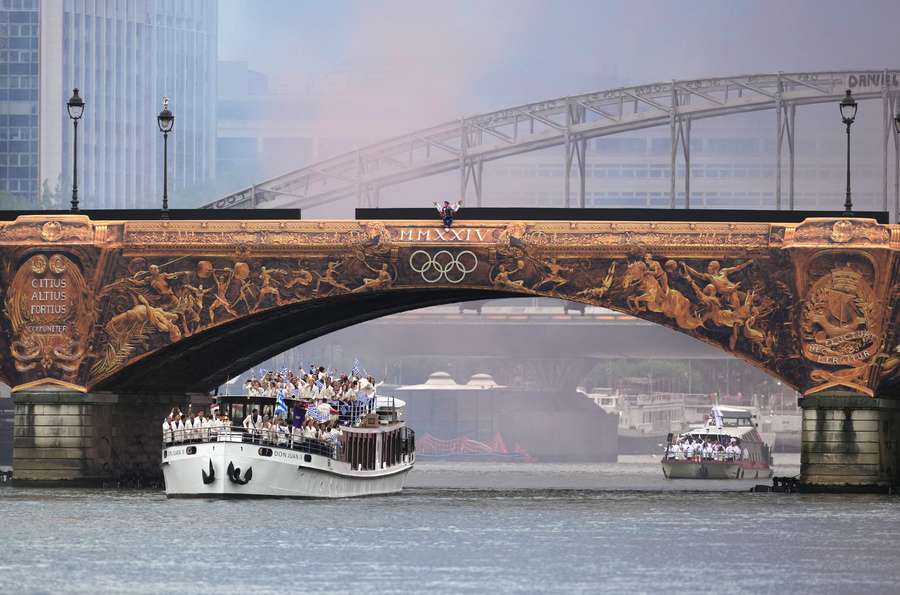 Athletes of Greece aboard a boat in the floating parade on the river Seine during the opening ceremony