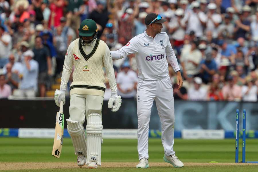 England's Joe Root (R) consoles Australia's Usman Khawaja (L) after he is bowled by England's Ollie Robinson on day three