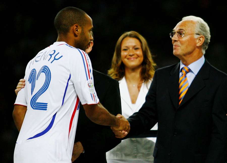 Thierry Henry of France shakes hands with Franz Beckenbauer following his team's defeat in a penalty shootout at the end of the FIFA World Cup Germany 2006
