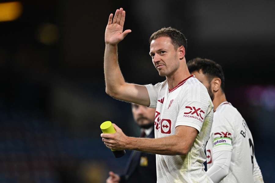 Manchester United defender Jonny Evans waves to fans on the pitch