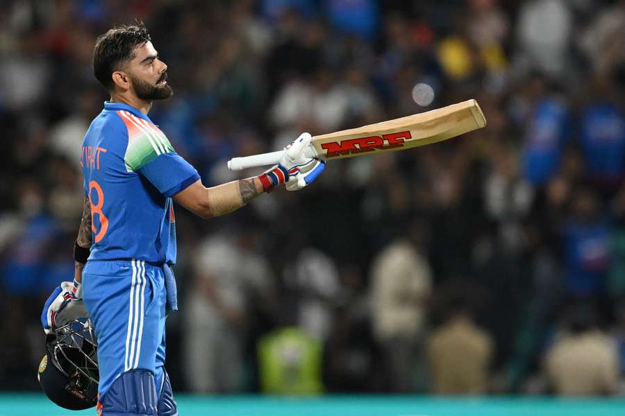 Virat Kohli celebrates after scoring his century in the first one-day international between India and West Indies Virat Kohli celebrates after scoring his century in the first one-day international between India and West Indies