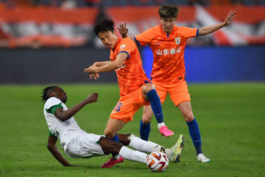 South Korean Son Jun-ho (centre), pictured playing for Shandong Taishan, was one of the players banned for life