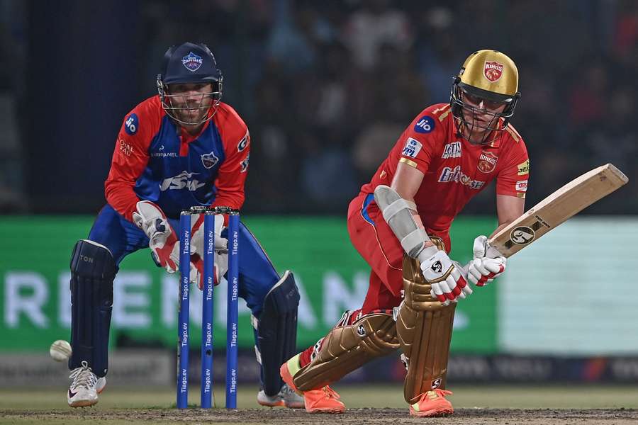 Punjab Kings' Sam Curran (R) plays a shot during the Indian Premier League (IPL) Twenty20 cricket match between Delhi Capitals and Punjab Kings