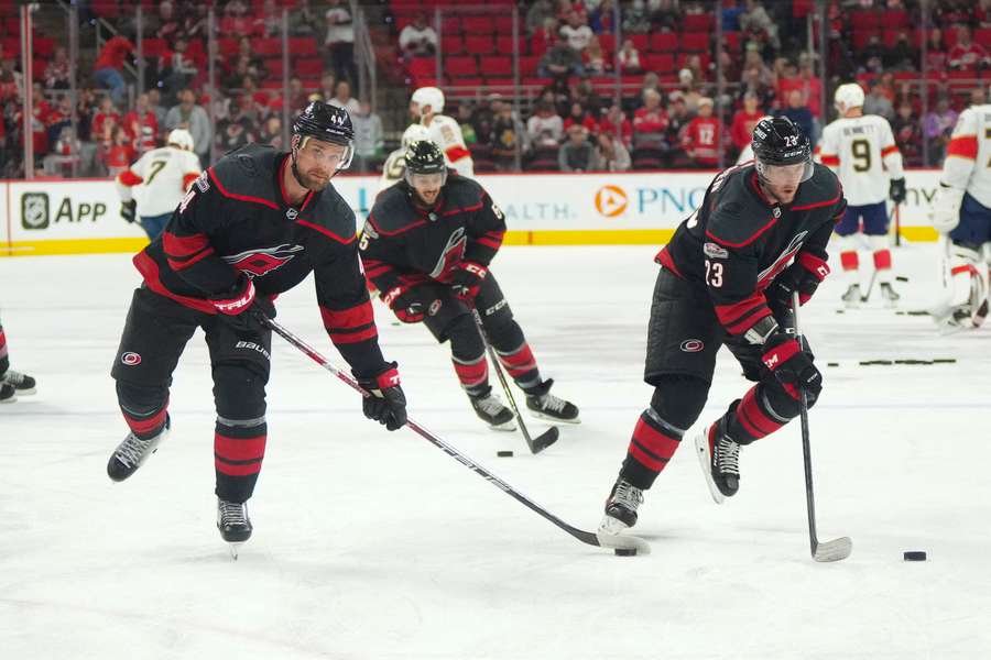 Carolina Hurricanes players skate before the game with the Panthers