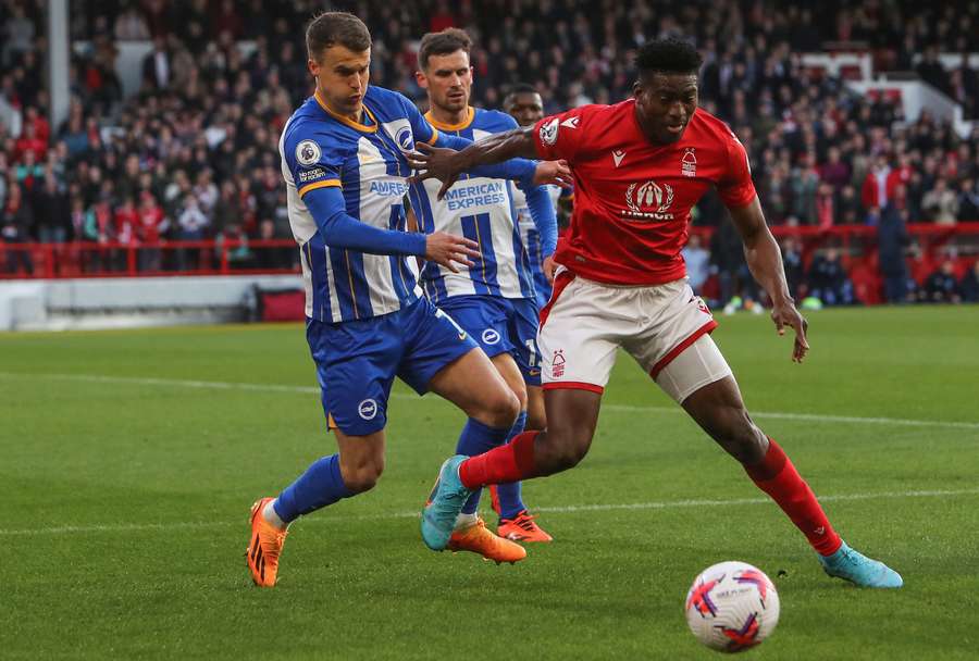 Brighton's Solly March fights for the ball with Nottingham Forest's Taiwo Awoniyi