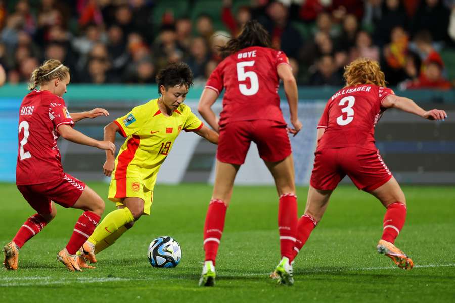 Linyan Zhang of China (C) fights for the ball with Josefine Hasbo of Denmark (L) 