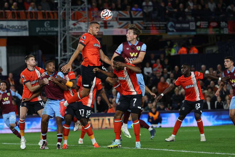 Luton Town's English striker #09 Carlton Morris heads the ball