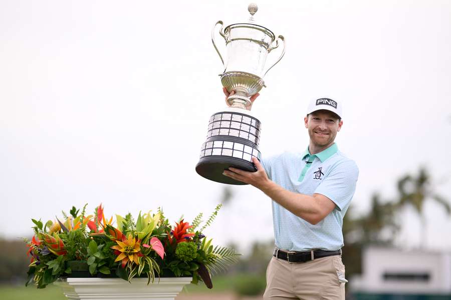 Brian Campbell poses with the trophy after putting to win a playoff hole in the final round of the Mexico Open