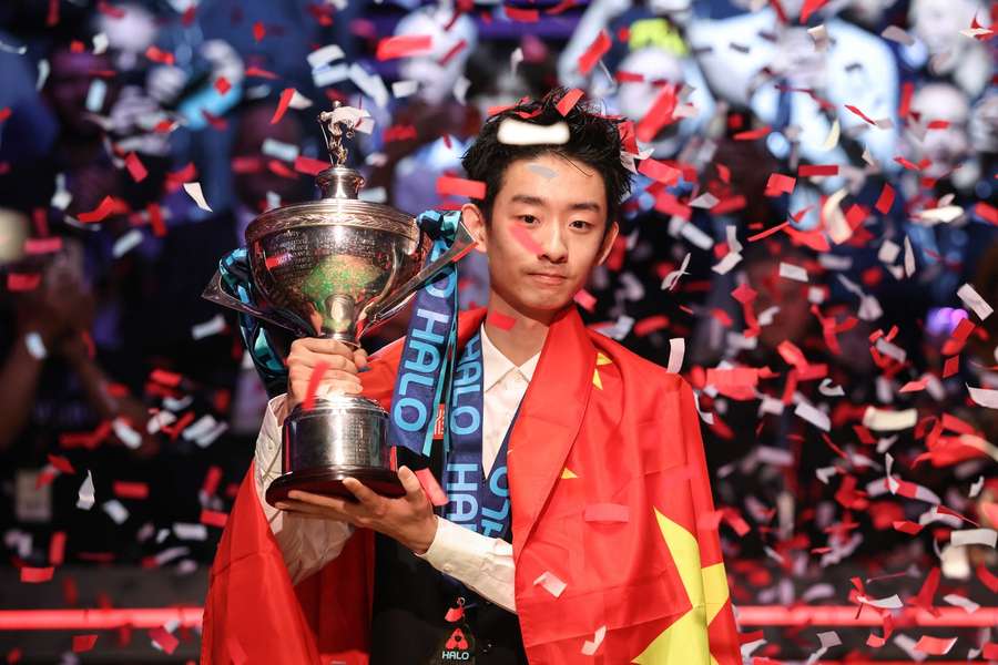 China's Wu Yize poses with the championship trophy