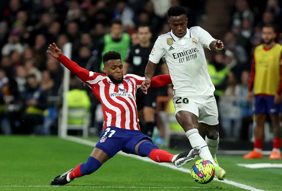 Real Madrid's Brazilian forward Vinicius Junior vies with Atletico Madrid's French midfielder Thomas Lemar