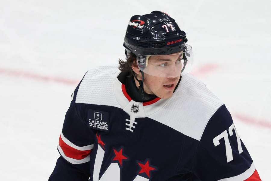 TJ Oshie of the Washington Capitals wears a neck guard as he skates against the New York Islanders