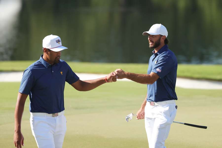 Tony Finau and Max Homa celebrate on the 11th green during Saturday morning foursomes.