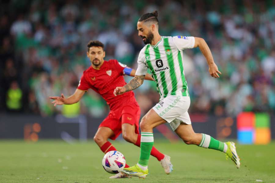 Isco of Real Betis runs with the ball whilst under pressure from Jesus Navas of Sevilla 