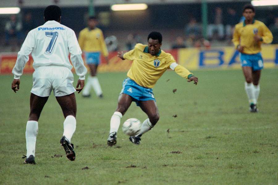 In this file photo taken on October 31, 1990, Pele plays the ball during a friendly soccer match to celebrate Pele's fiftieth birtday in Milan