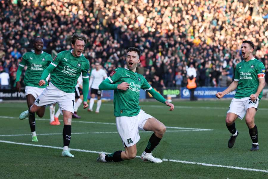 Plymouth players celebrate scoring against Liverpool in the fourth round