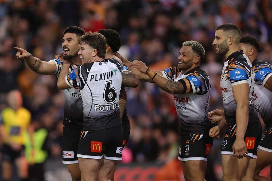 Terrell May and his Wests Tigers teammates react to a try scored at the weekend.