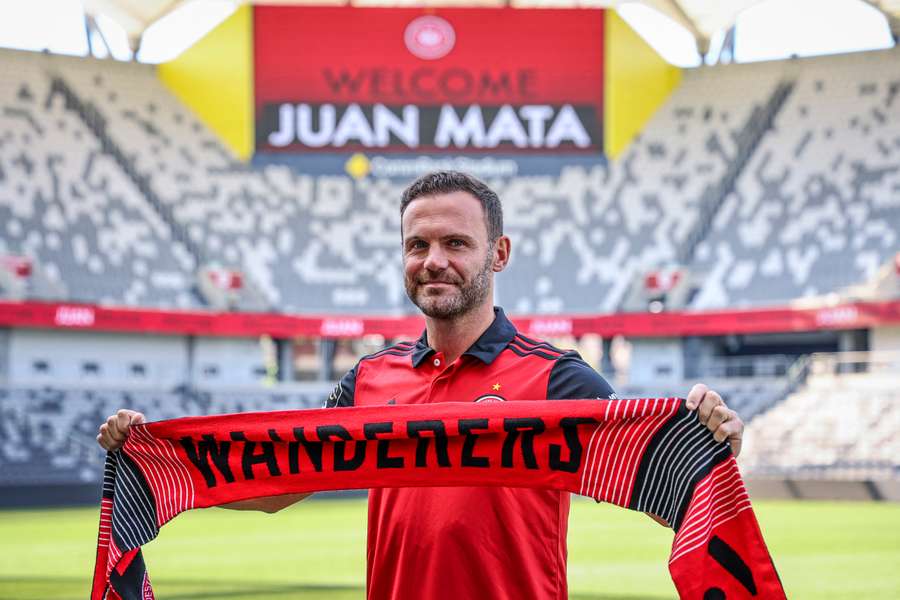 Juan Mata stands with a Western Sydney Wanderers scarf after a press conference at CommBank Stadium