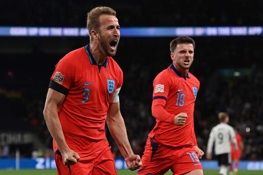 England's striker Harry Kane (L) celebrates scoring the team's third goal 