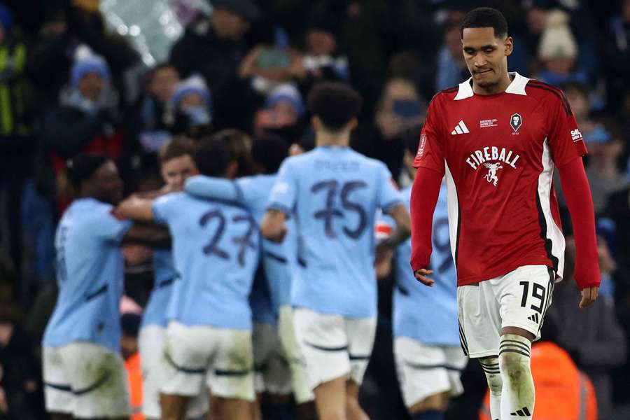 Hajo Mnoga reacts as Man City celebrate scoring their fourth goal