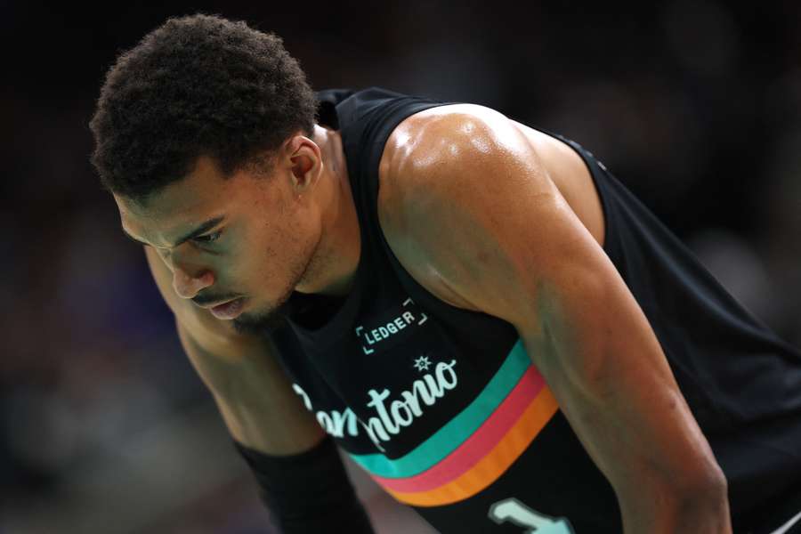 Spurs' Victor Wembanyama takes a break during a game against the Cleveland Cavaliers